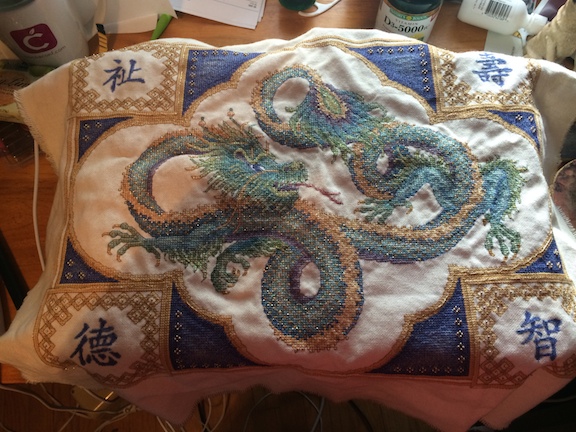 Dragon project requiring over 50 threads, including metallics and beads.